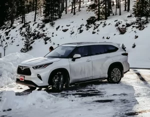 a parked toyota highlander on a snowy hill